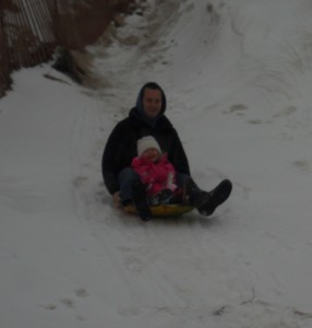 Skylar sledding with Ad