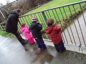 Watching sticks float under the bridge